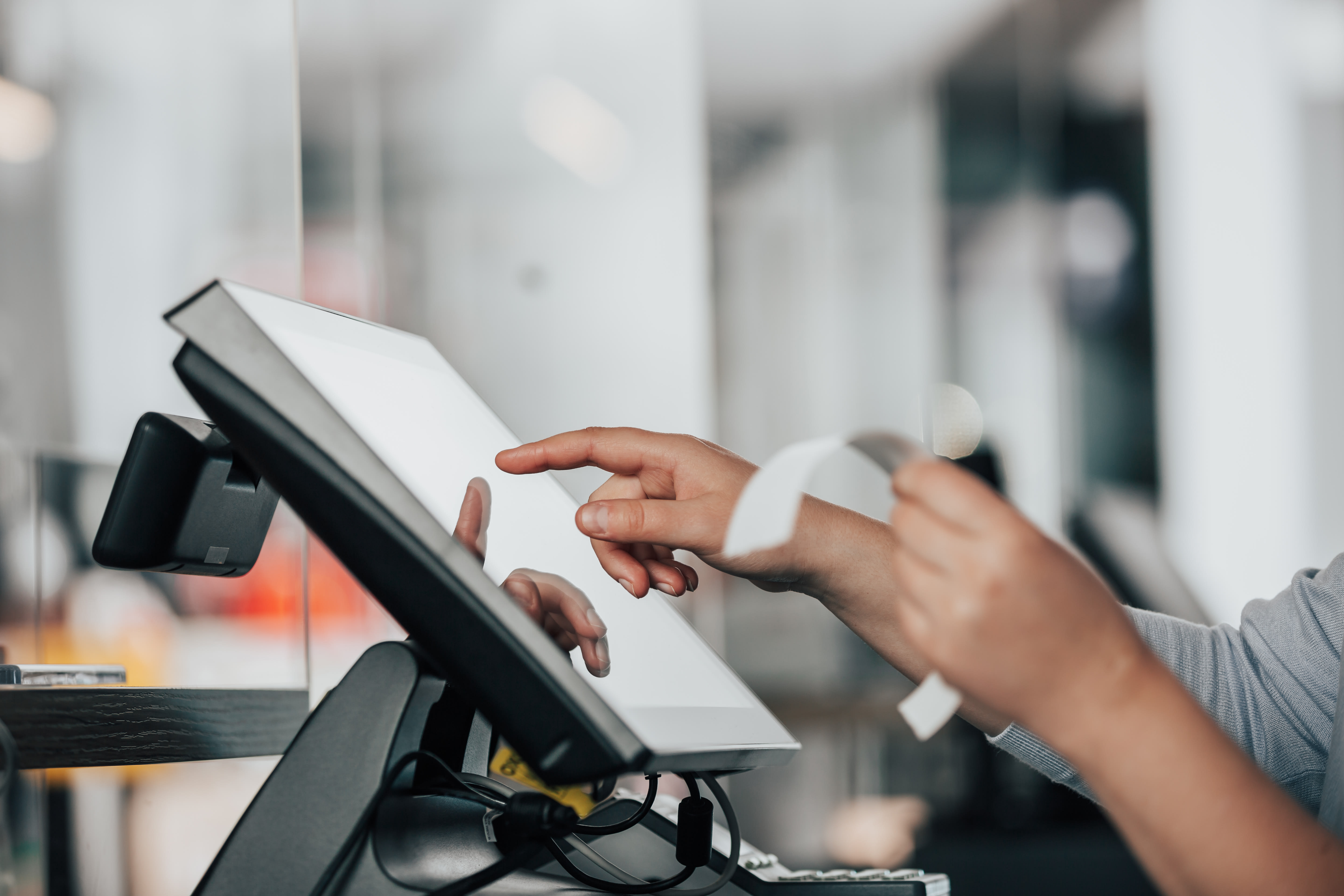 Cashier’s hands on an electronic till
