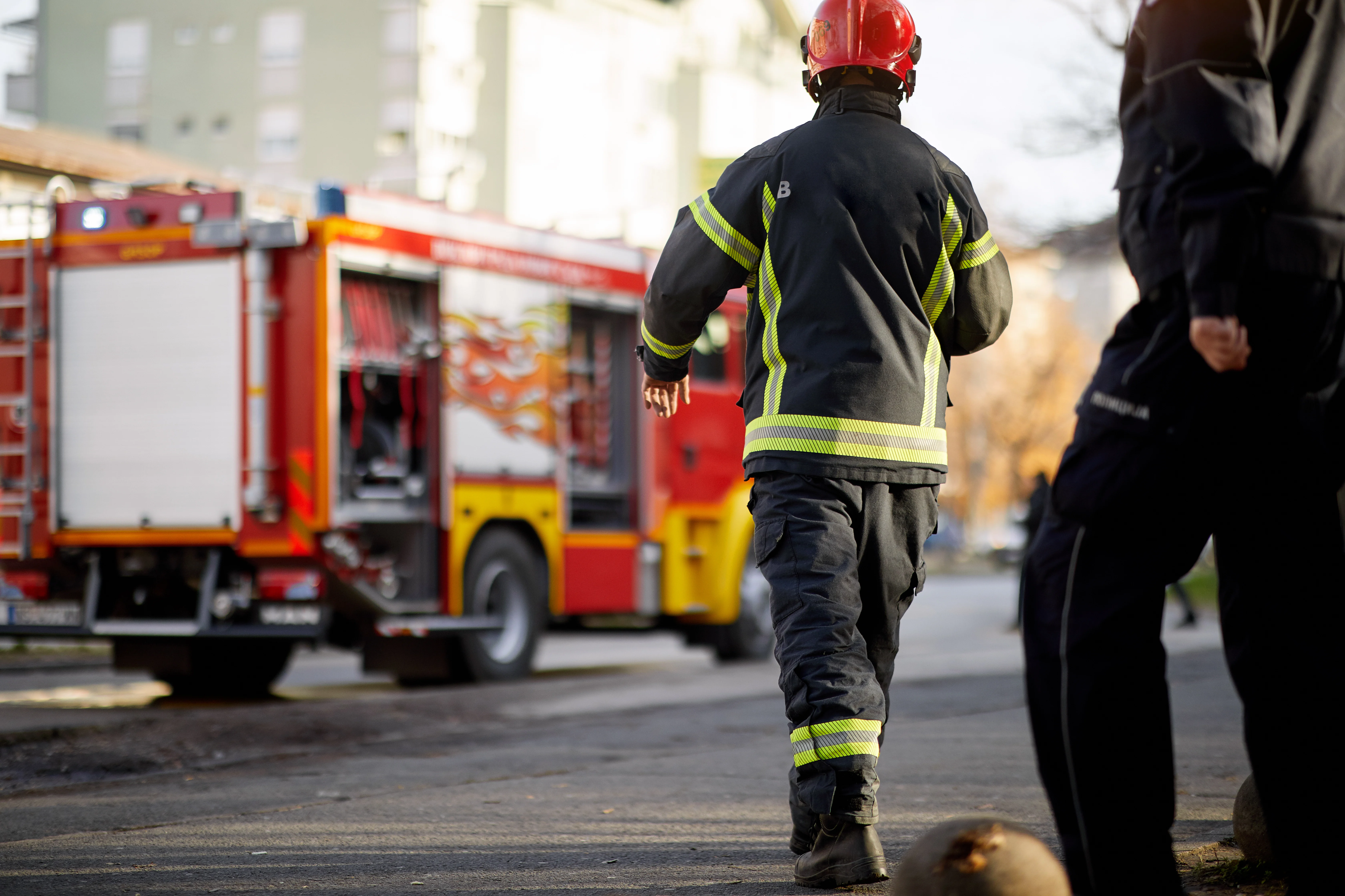 Firefighter walking towards a fire engine