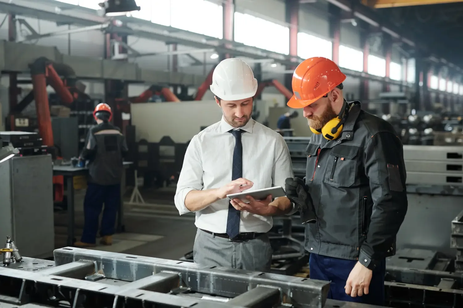 Photo of two manufacturing workers using a tablet device