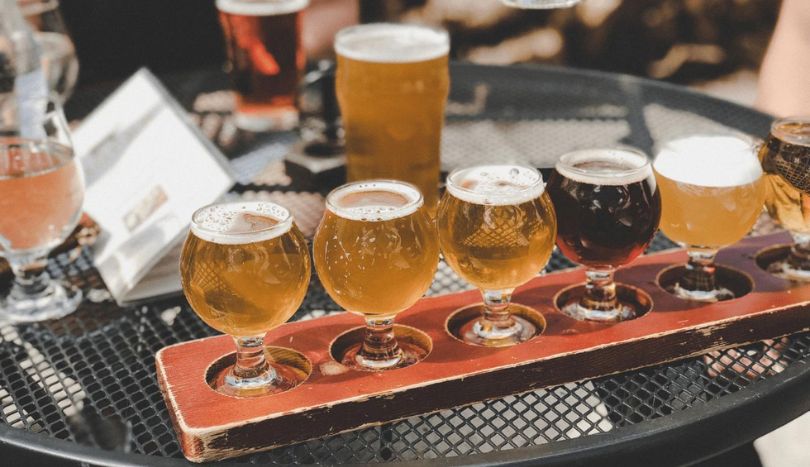 Glasses full of beer are placed on the table