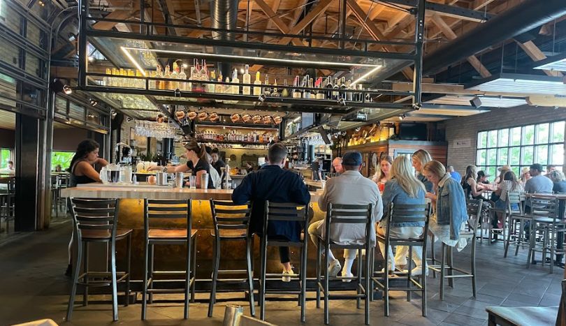 people sitting on chairs and waiting for breakfast at Montana Ale Works