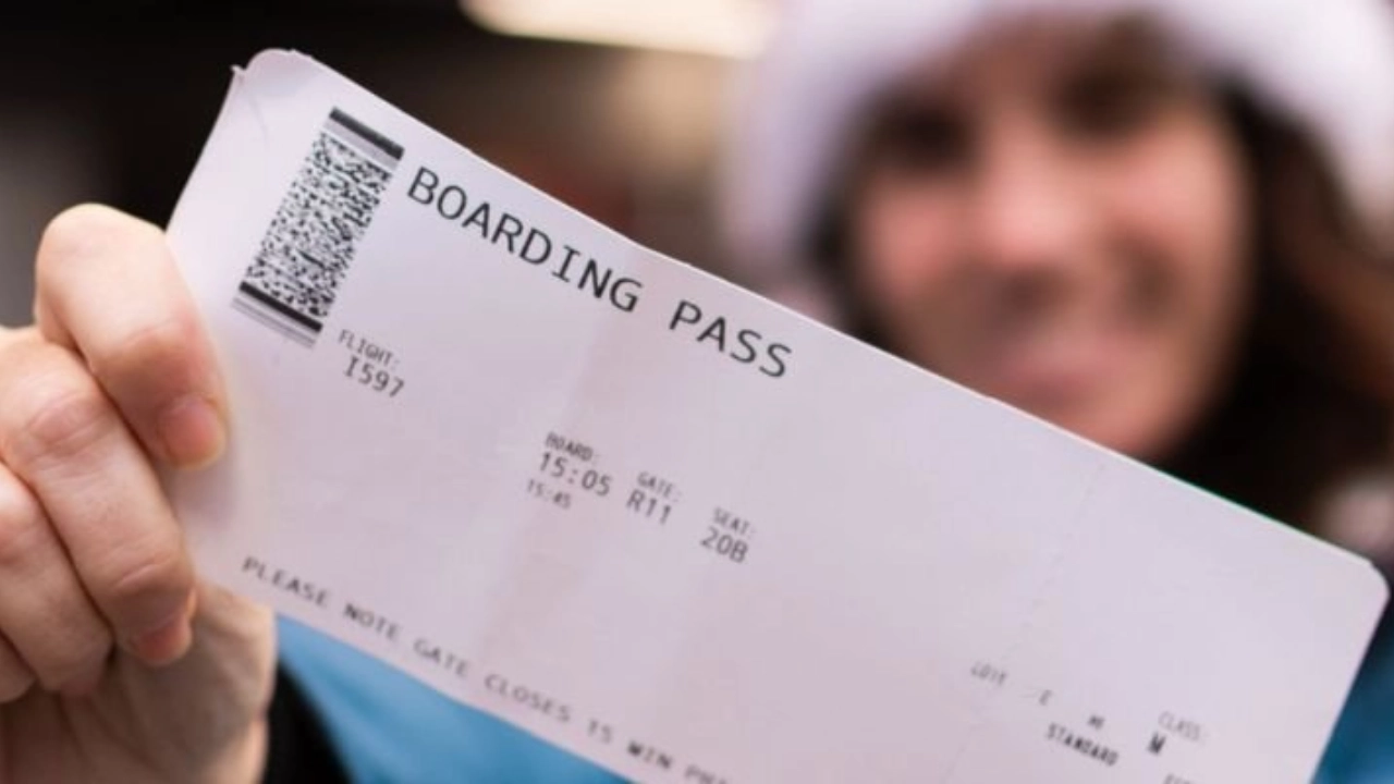 A person holding a boarding pass