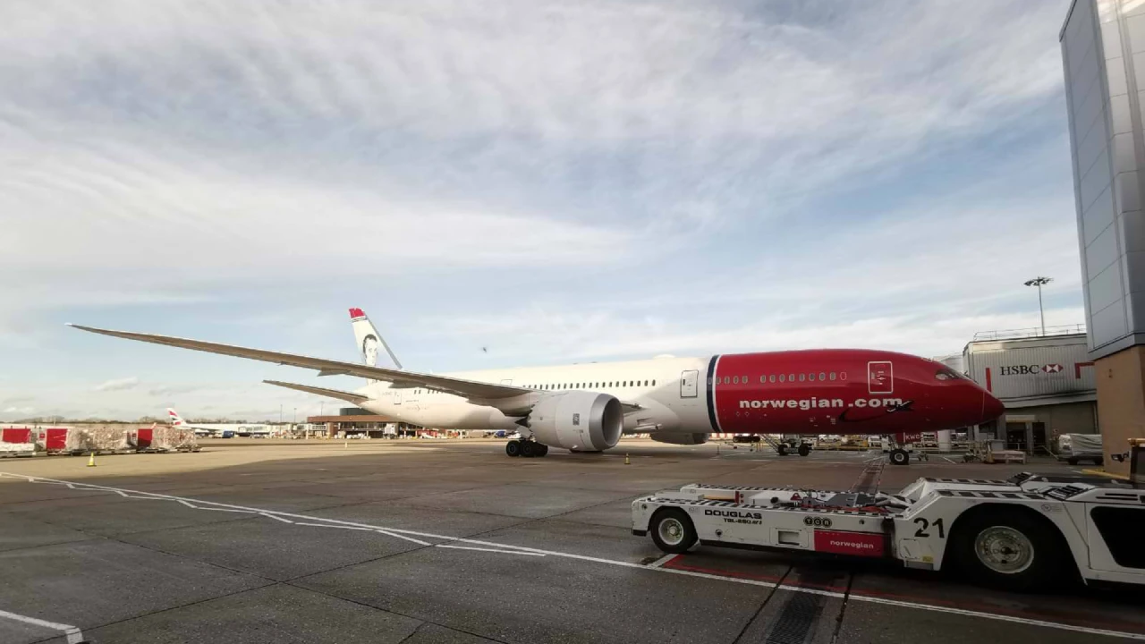 Norwegian Air staff explaining Cancellation Protection to customer