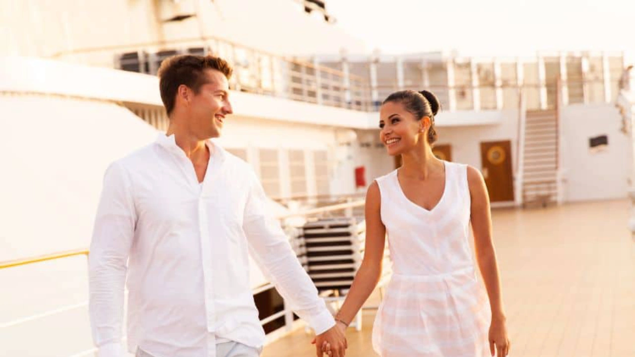 Young couple enjoying a romantic sunset on cruise