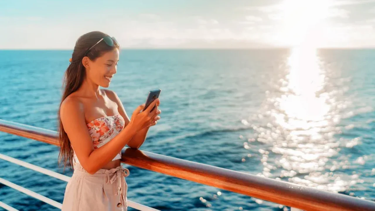Girl using mobile phone on Carnival Cruise, exploring free WiFi availability