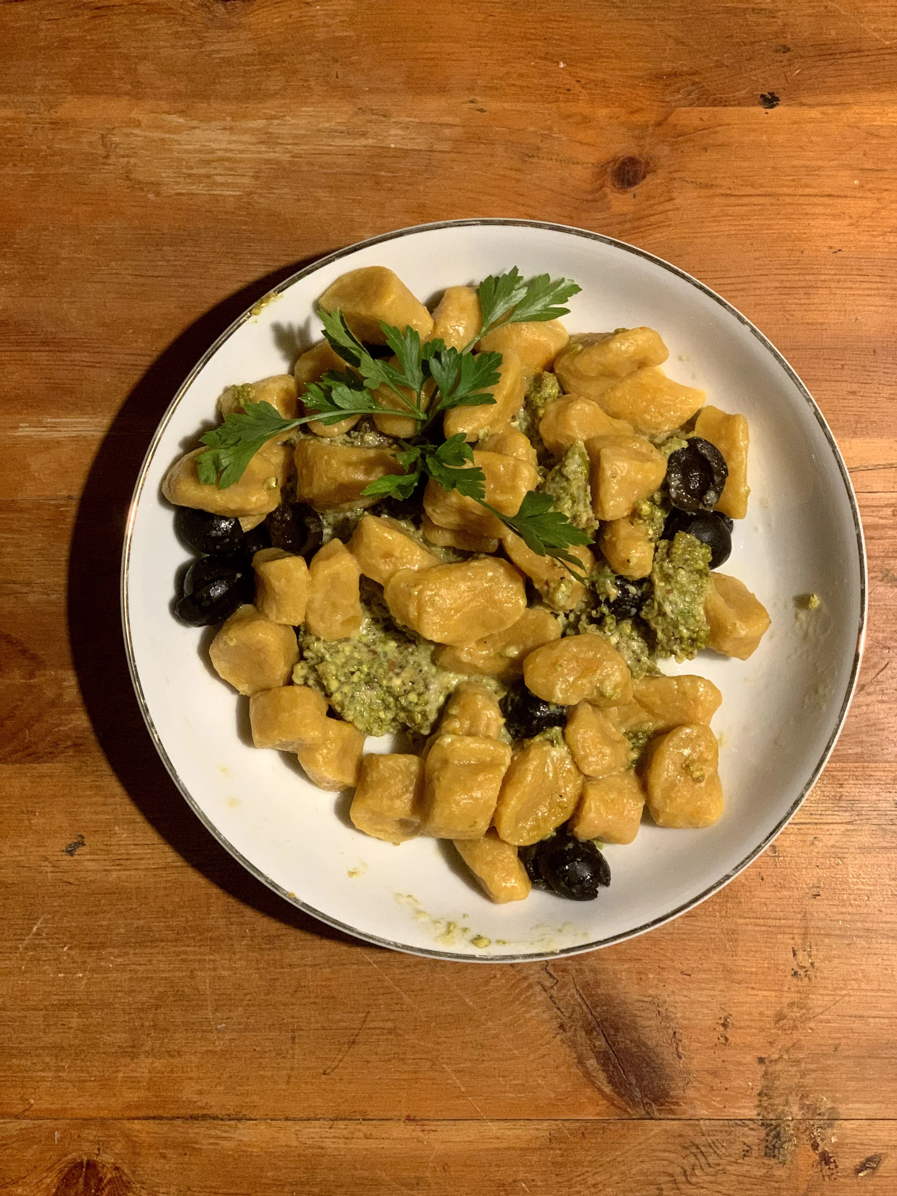 homemade-vegetarian-pumpkin-gnocchi-with-pistachio-pesto-and-black-olives