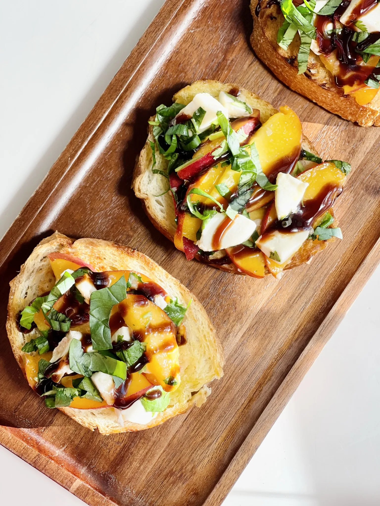 peach-and-mozzarella-crostini-with-truffle-balsamic-glaze-and-basil