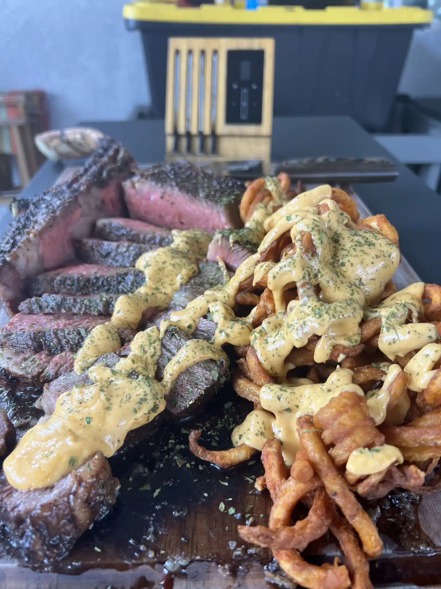 grilled-tomahawk-steak-with-curly-fries-and-cheese-sauce