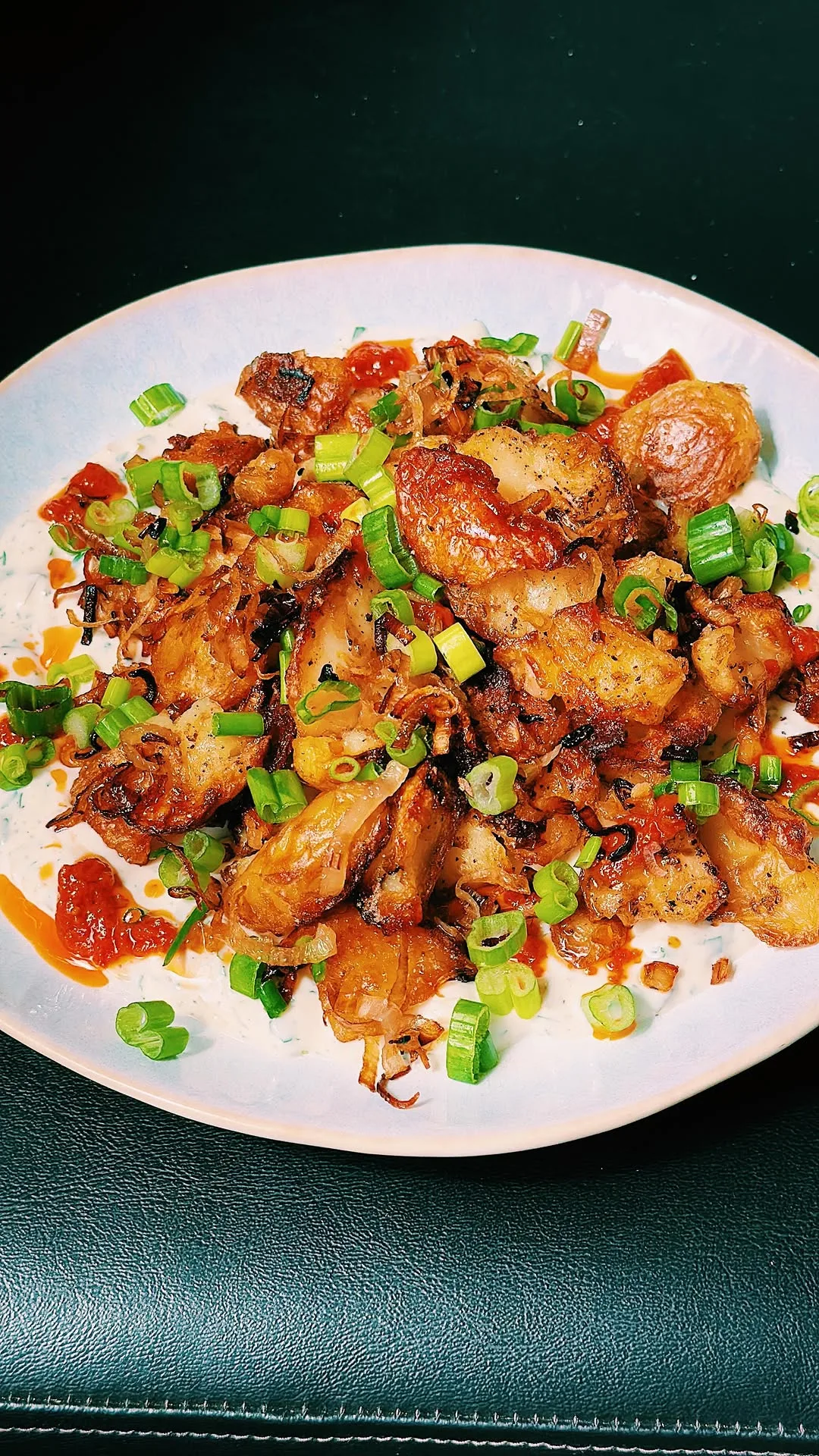 crispy-smashed-potatoes-with-a-harissa-oil-on-a-bed-of-the-best-yoghurt