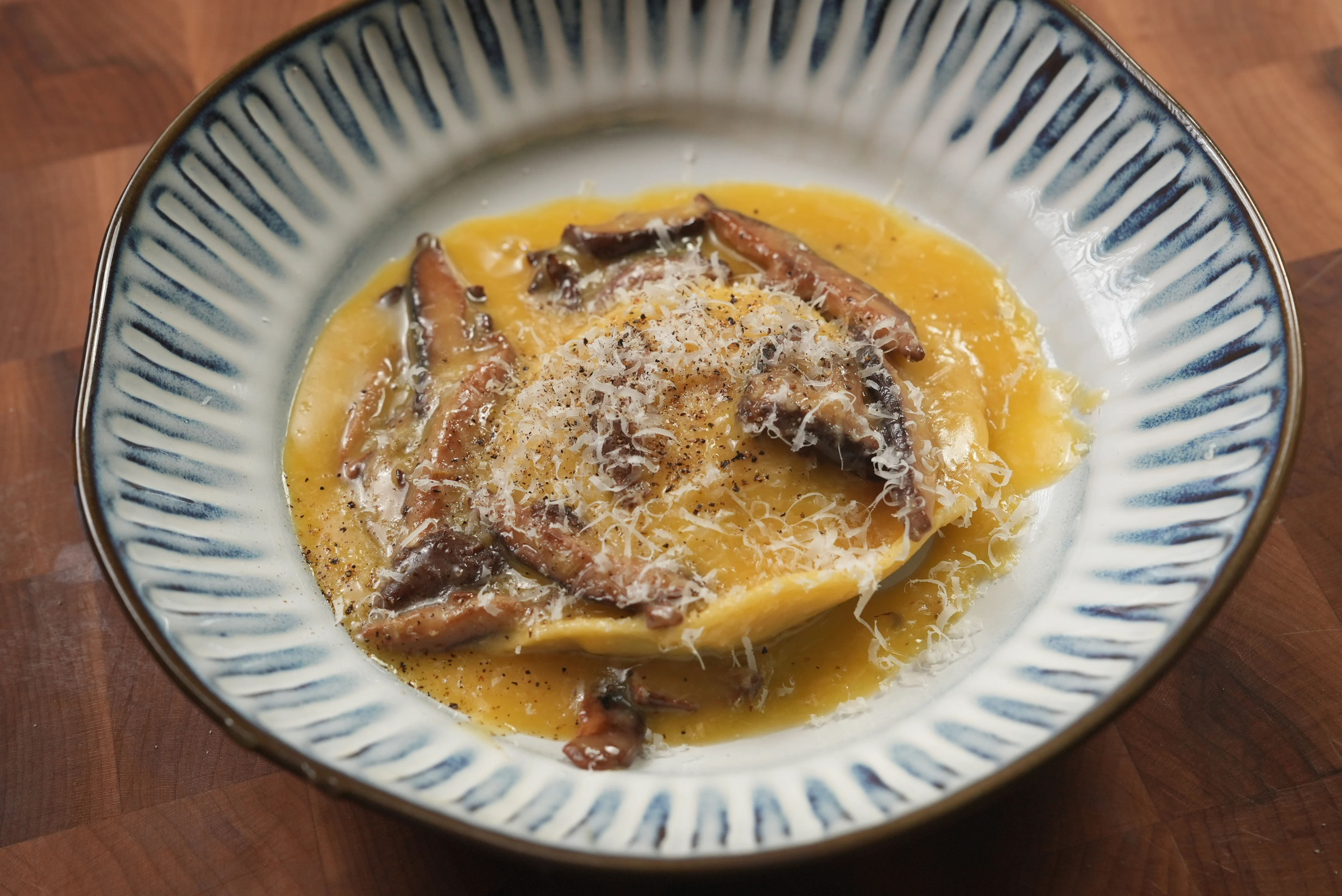 raviolo-al-uovo-with-caramelized-leek-and-mushrooms