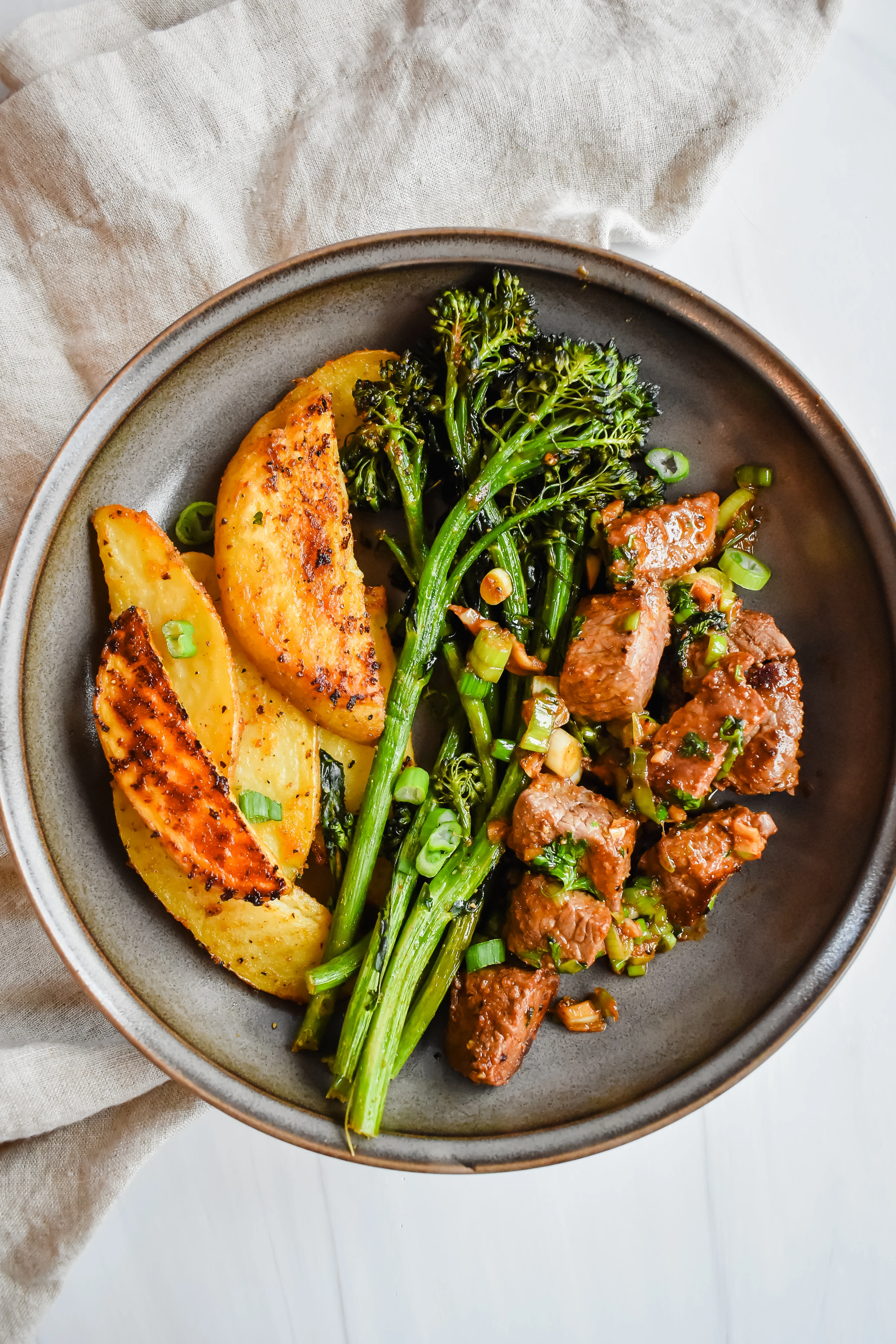 garlic-butter-steak-bites-with-broccolini-and-potato-wedges