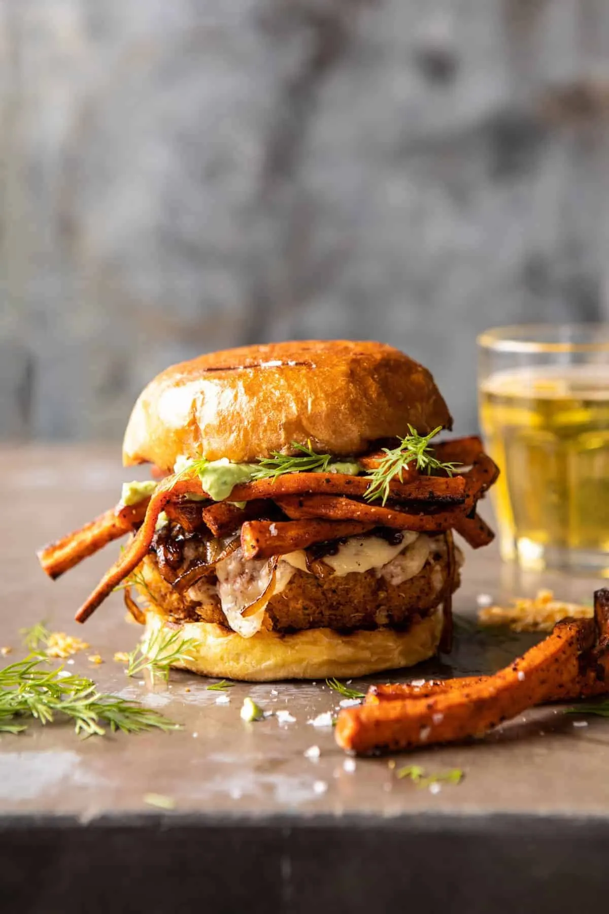 crispy-quinoa-burgers-topped-with-sweet-potato-fries-and-beer-caramelized-onions
