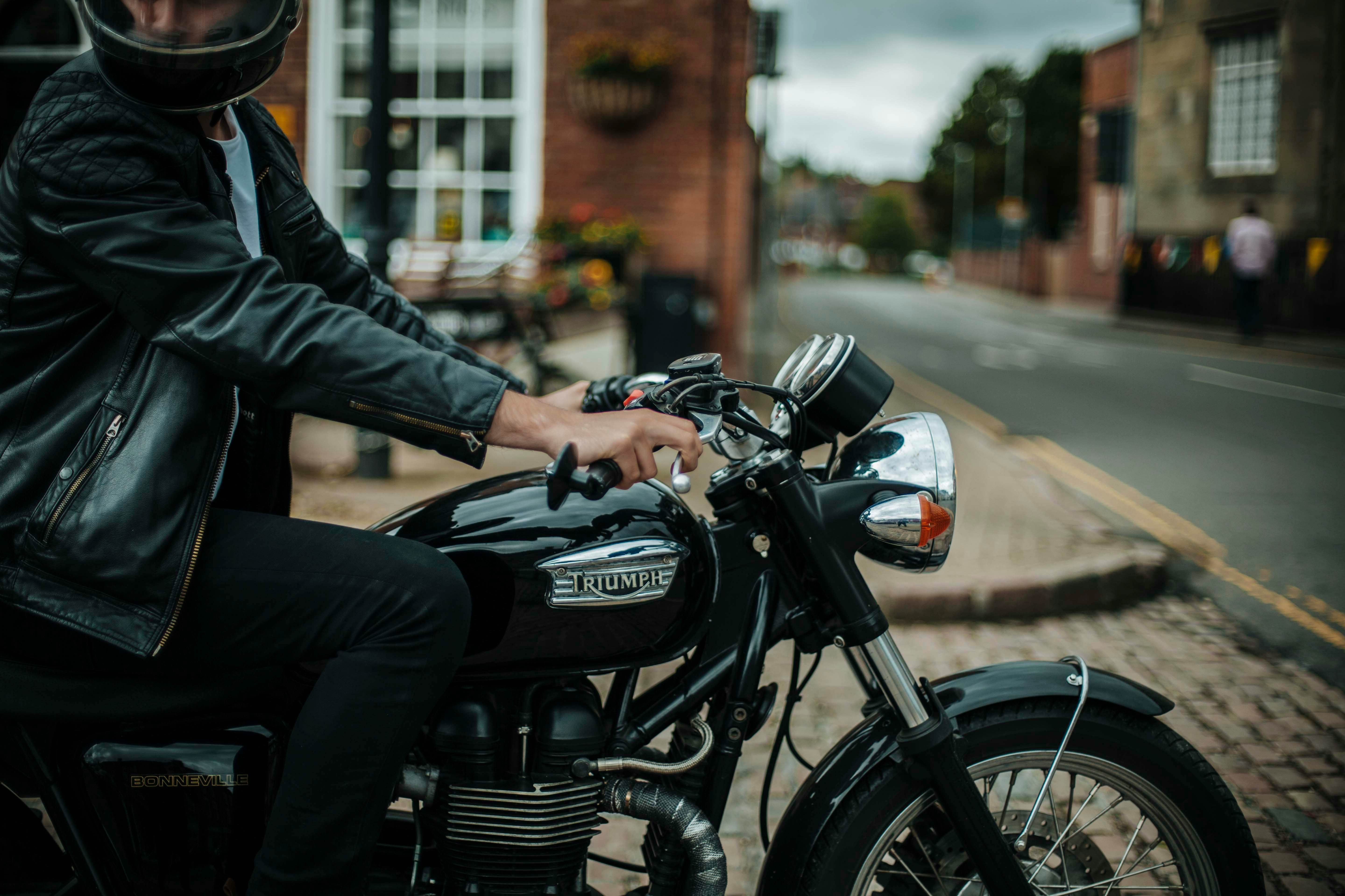 Man in helmet sitting on parked motorcycle