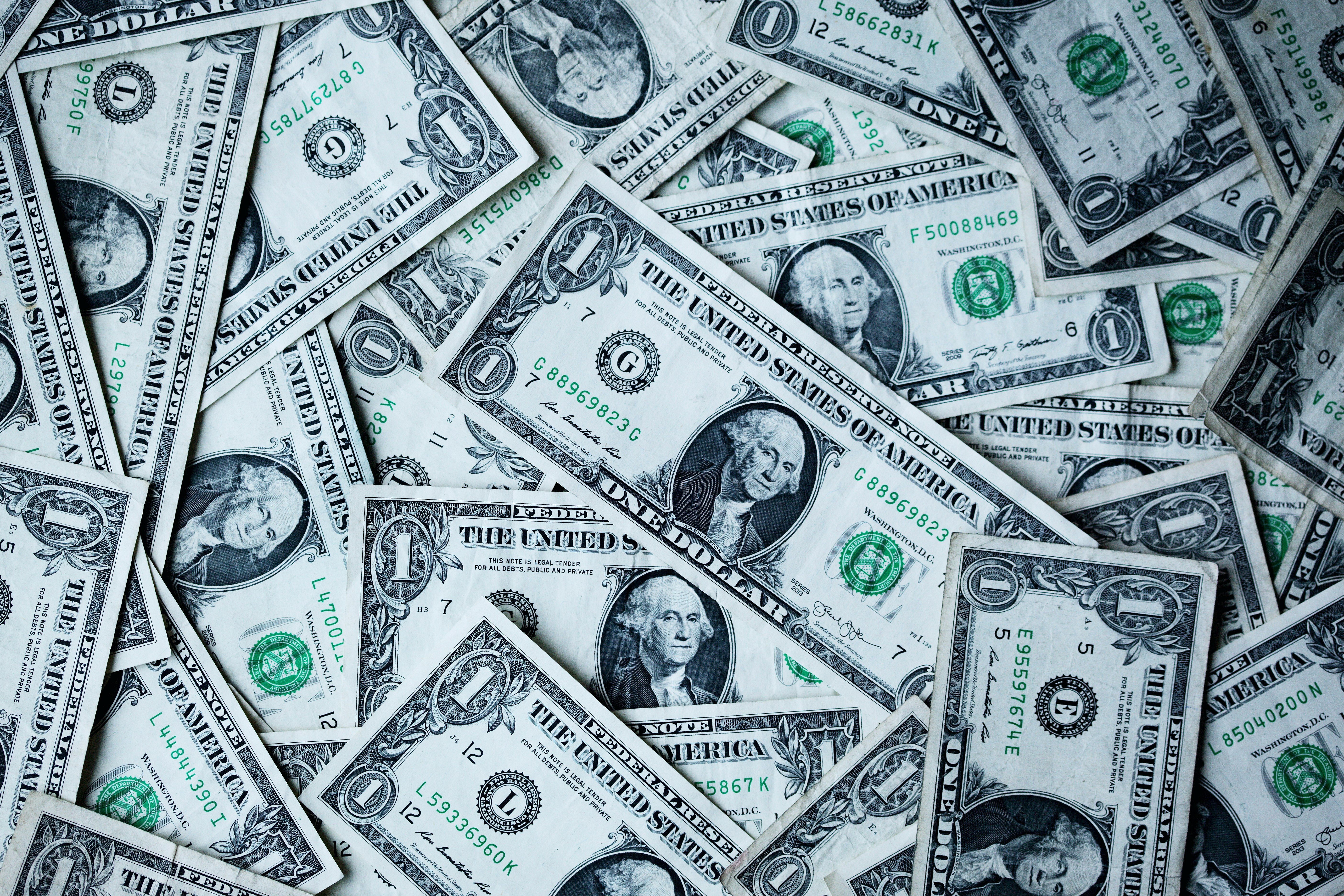 a pile of $1 bills scattered artfully