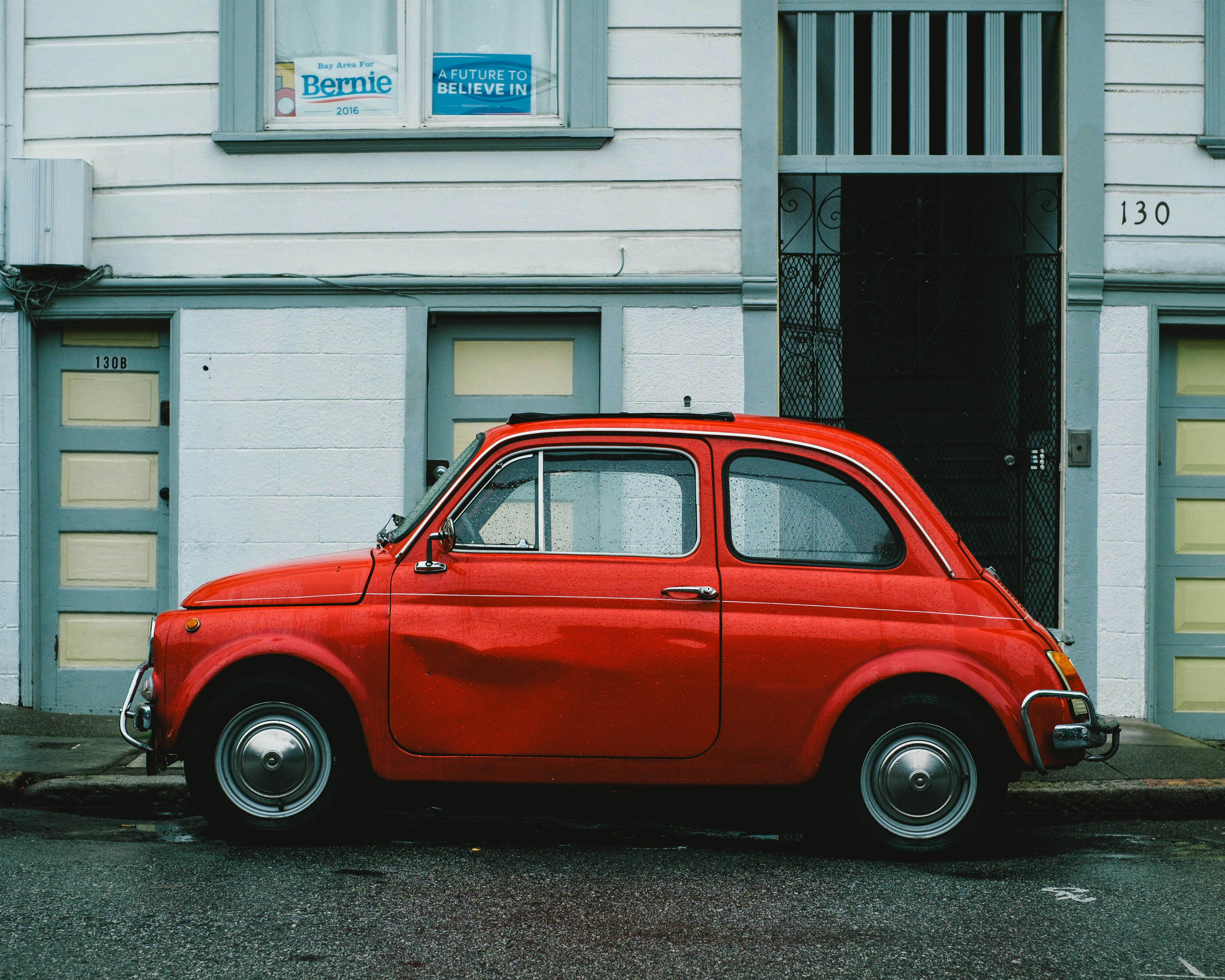 dented red vintage 2 door car