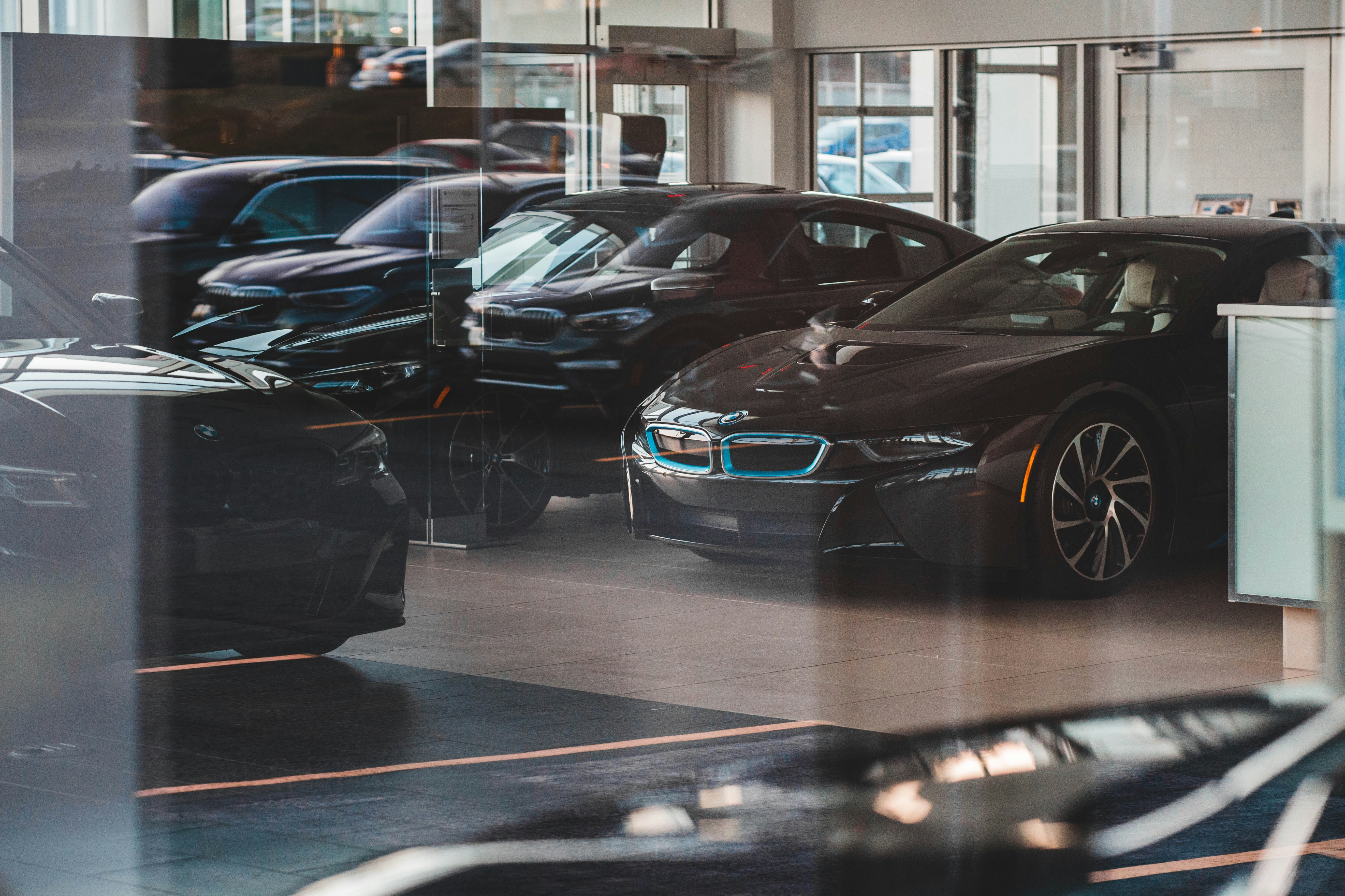 BMWs through shiny dealership window