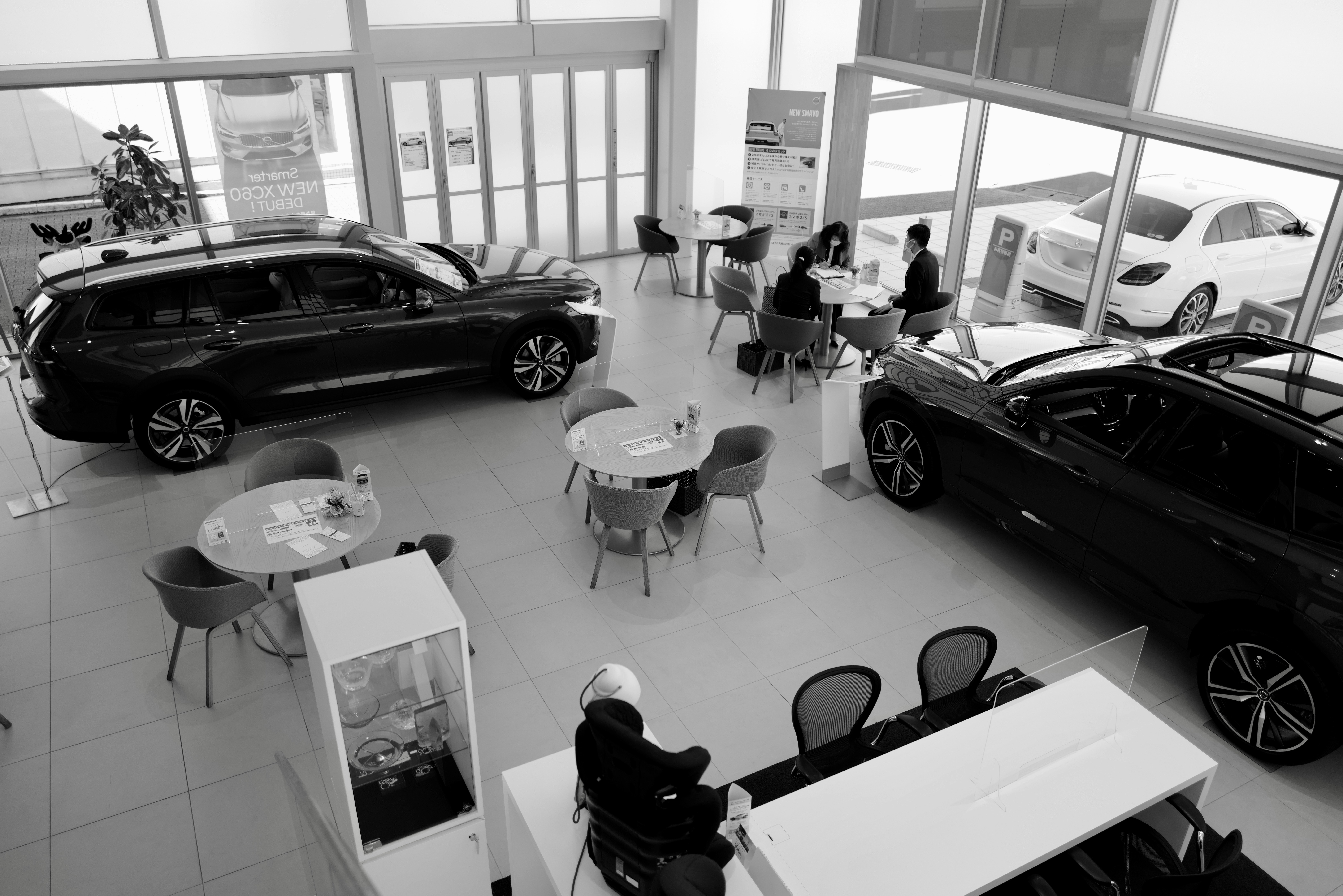 black and white image from above of the inside of a car dealership