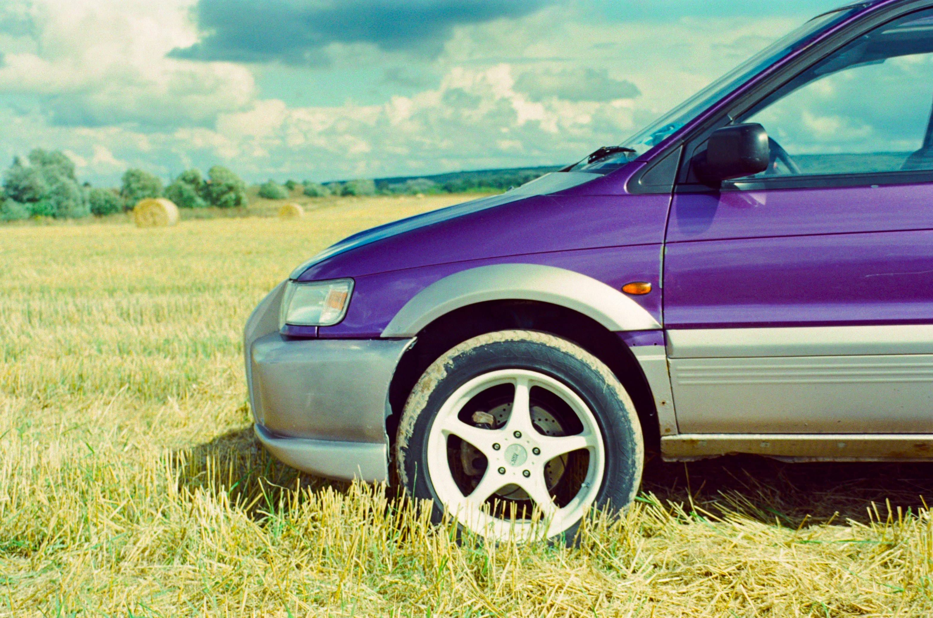 Old purple van in a field