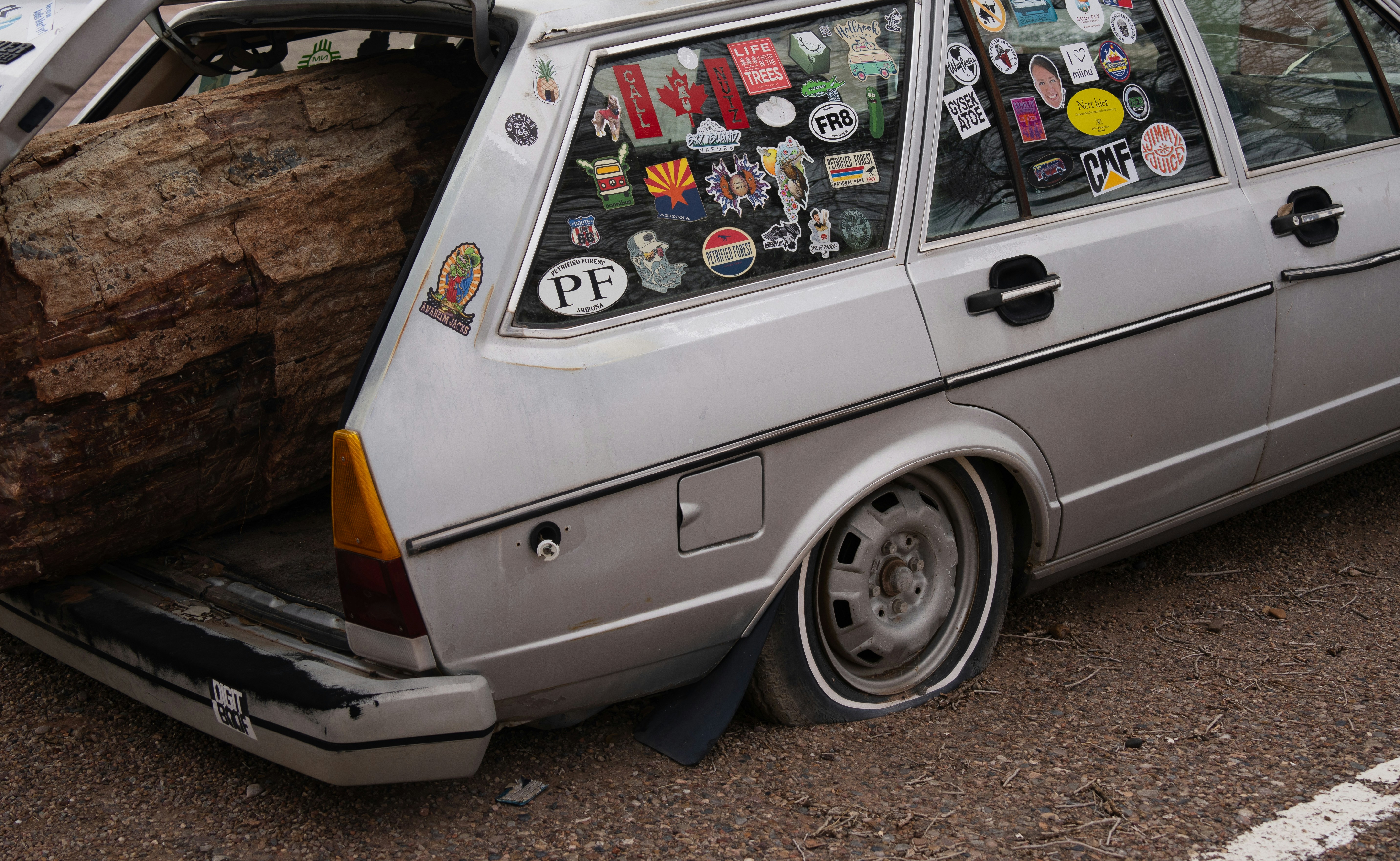Old hatchback with windows covered in stickers