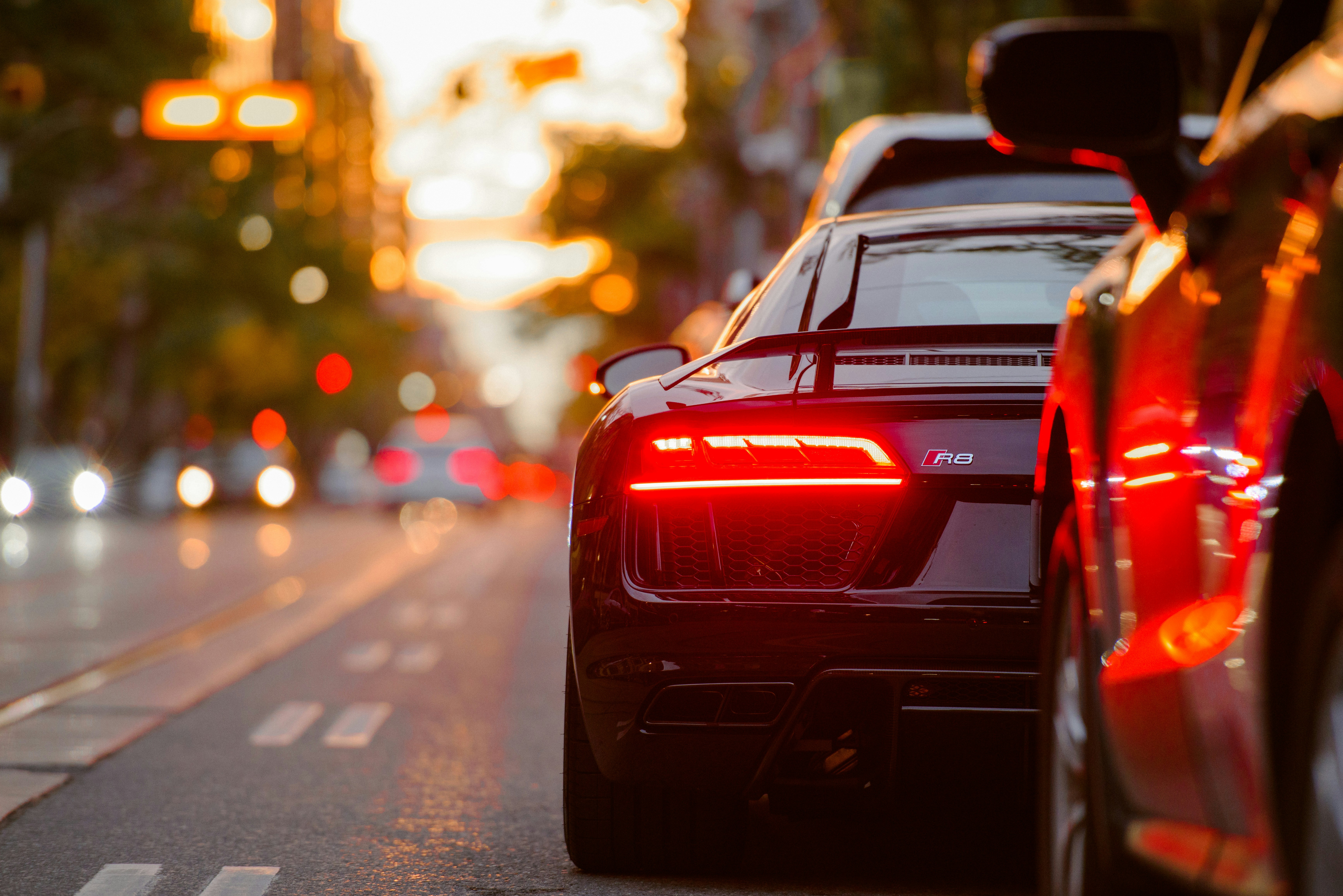 a row of cars in traffic at sunset