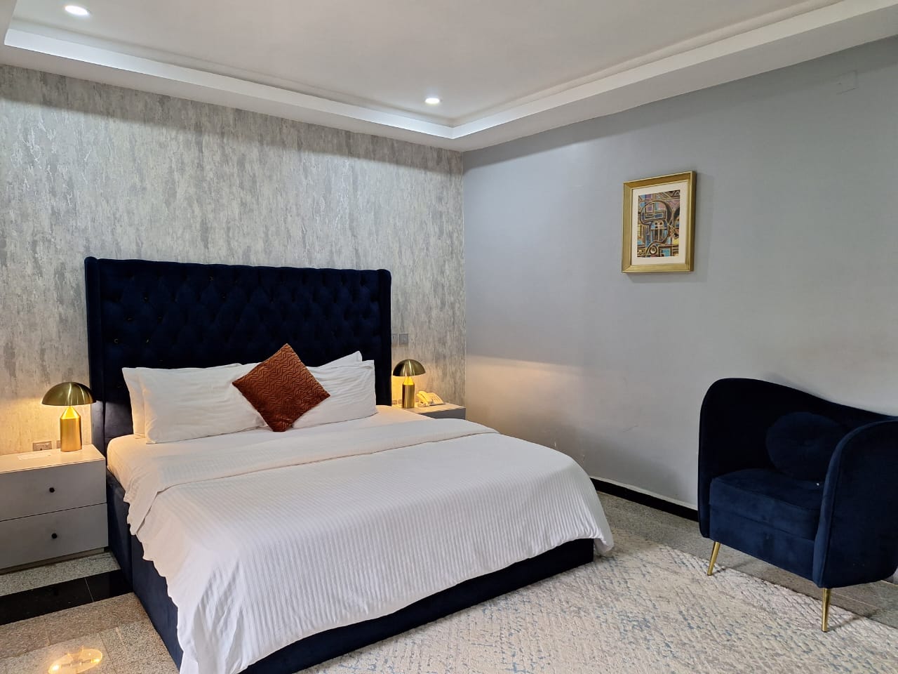 Resort-style pool with wooden deck and tropical landscaping