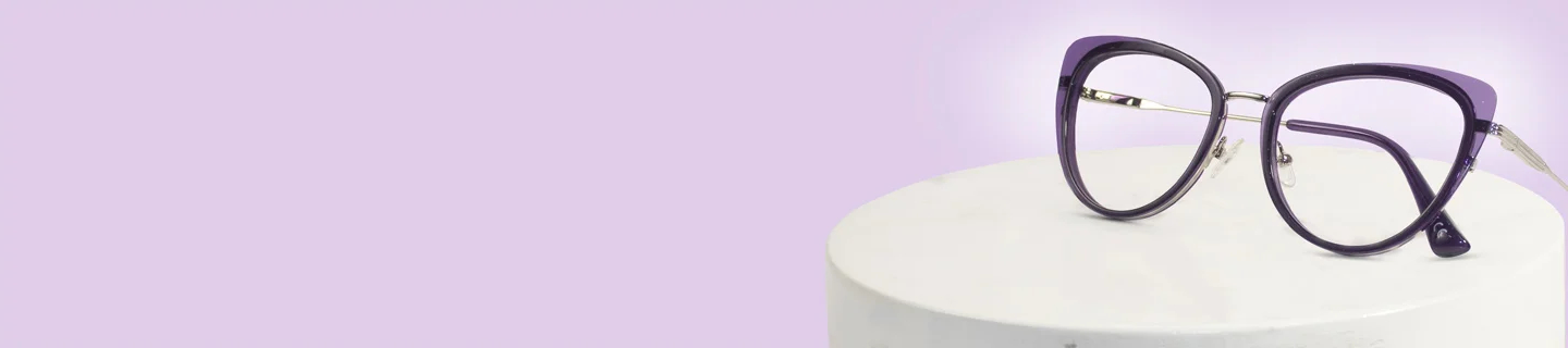Image showing a sleek pair of purple cat-eye prescription glasses with thin silver metal detailing on the sides, resting on a white cylindrical display stand, advertising purple glasses.