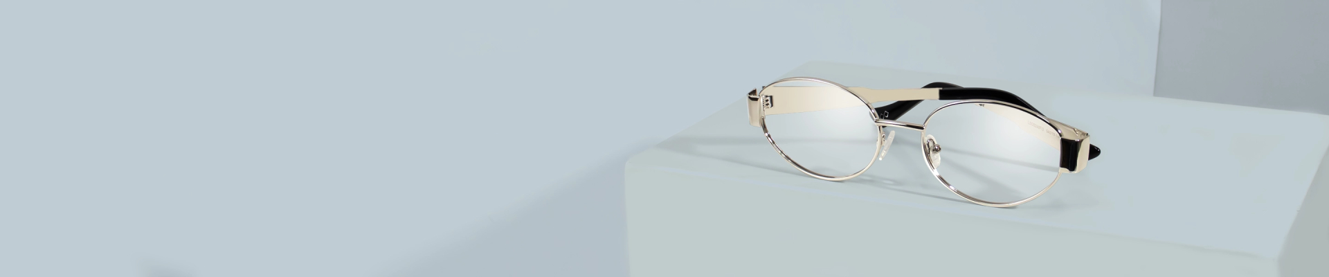 Bold amber-coloured oval eyeglasses with thick round rims, displayed on a clean white background