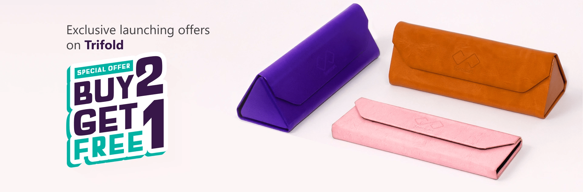Banner advertising ‘Exclusive Launching Offer On Trifold, Buy 2 Get 1 Free’ featuring three pastel-coloured Specscart trifold cases in pink, purple, and brown, arranged in pairs on a pale background.