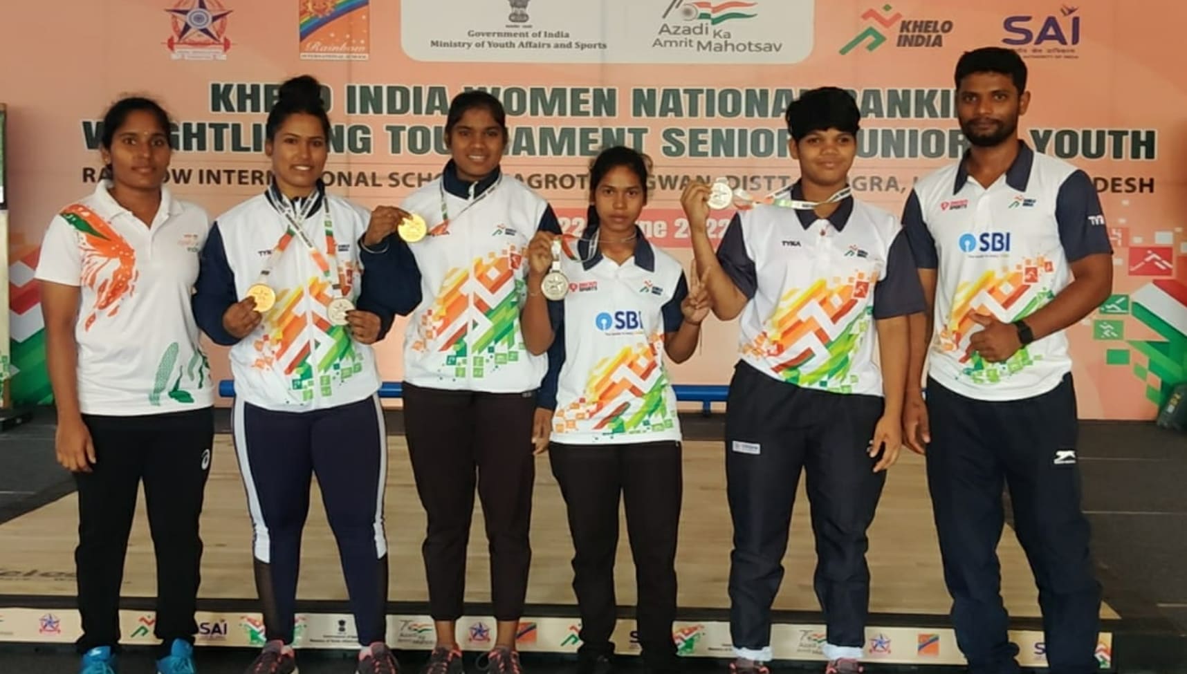 Coach Loganthan with medal winners at Khelo India Women National Ranking Weightlifting Tournament.
