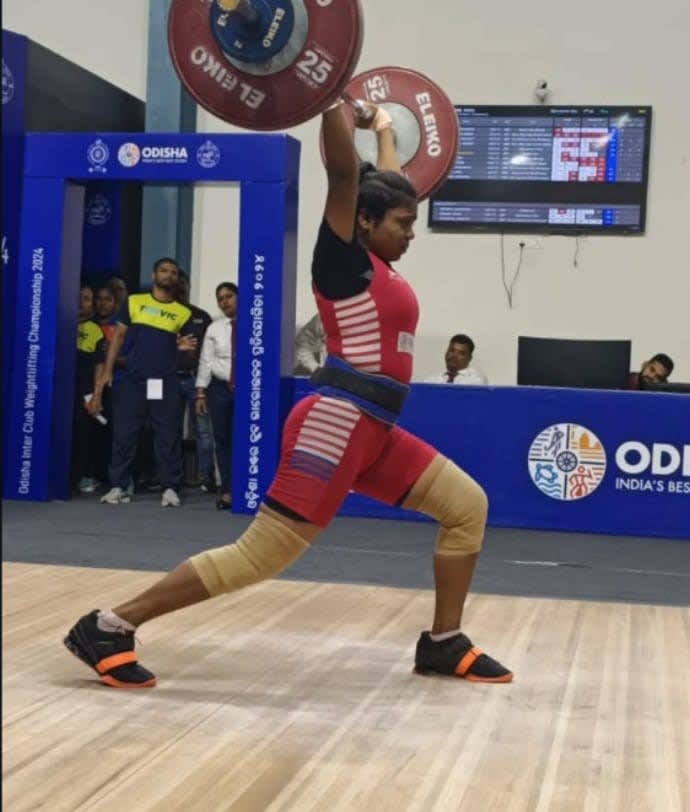Coach Loganathan's student performing weightlifting at a championship in Odisha.