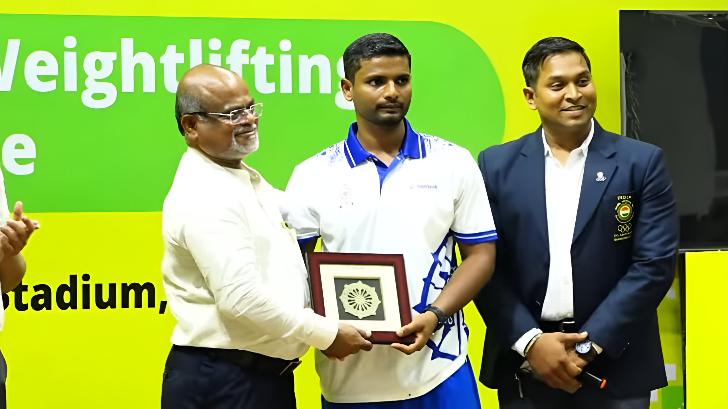 Coach Loganthan receiving an award.