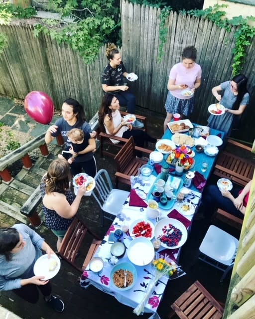 Community gathering around a table in the backyard