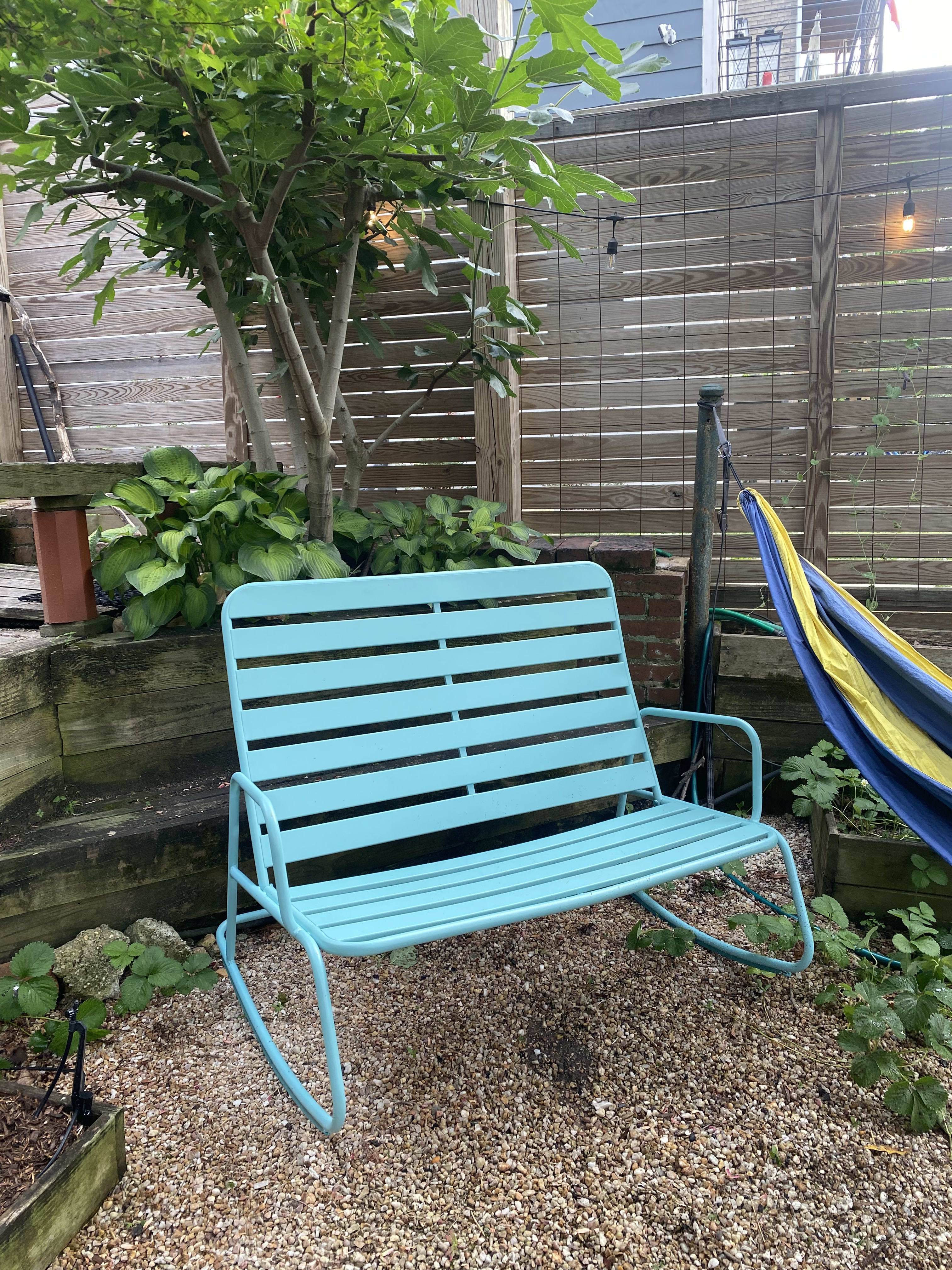 Colorful turquoise bench in garden patio