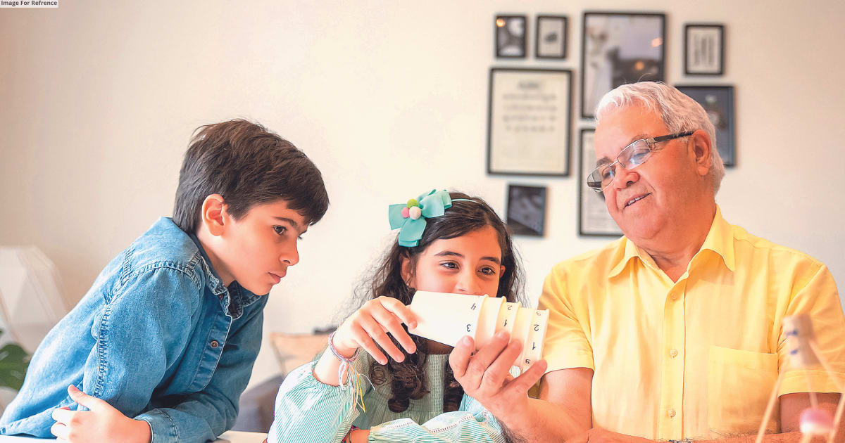Elderly Indian couple enjoying family time in a vibrant cultural setting.