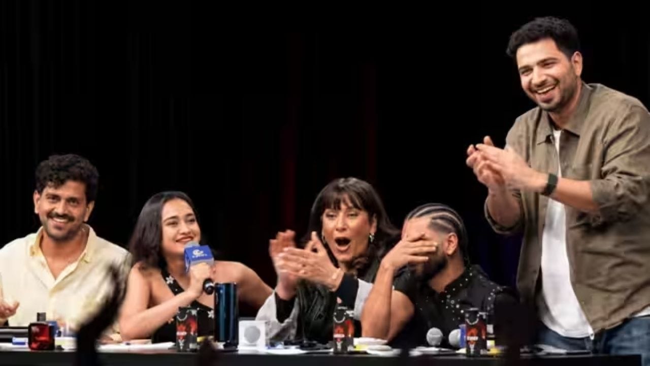Samay Raina and Sharon Verma laughing together on stage.