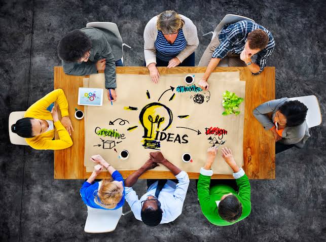 A diverse team brainstorming creative solutions in a modern office.