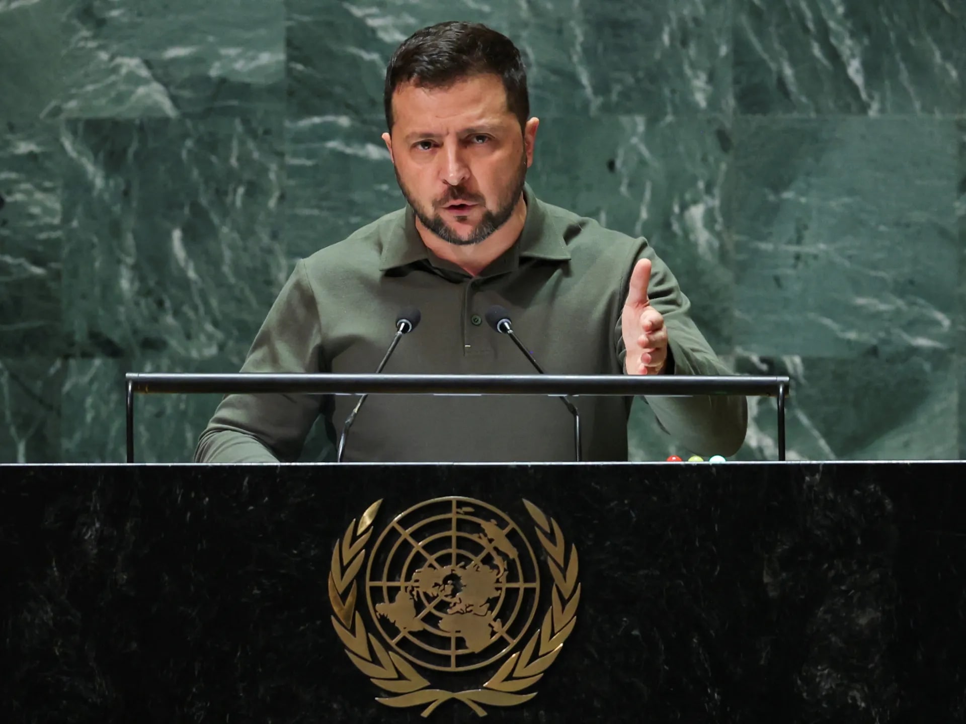 Ukrainian President Zelenskyy speaking at a podium.