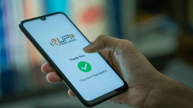 A smartphone displaying the UPI interface with digital payment icons.