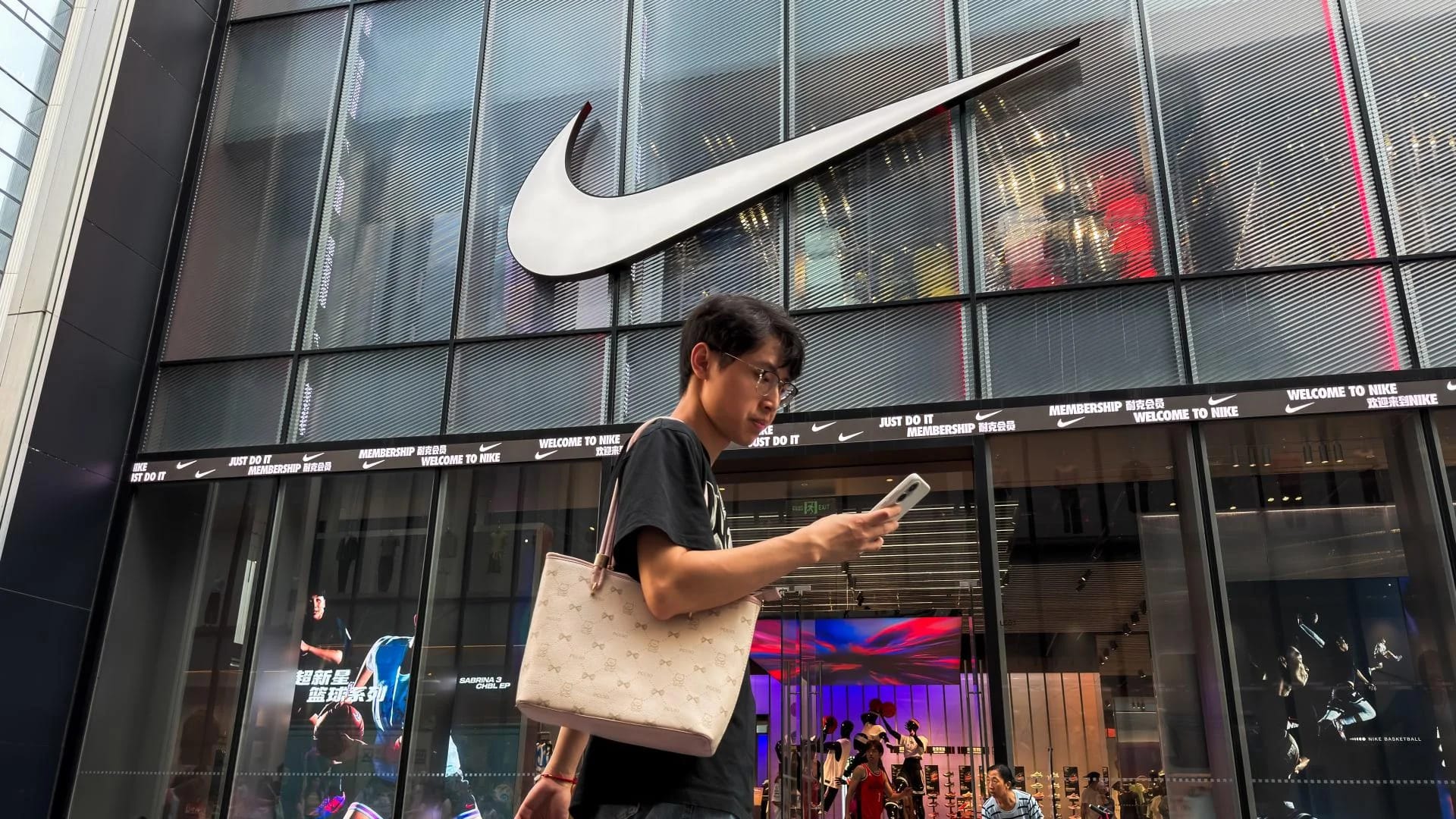 Nike logo with a declining graph symbolizing market loss.