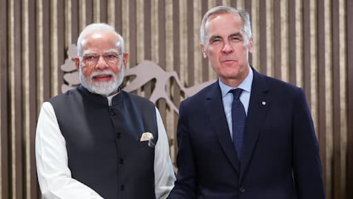 PM Modi shaking hands with Canadian officials during a bilateral meeting.