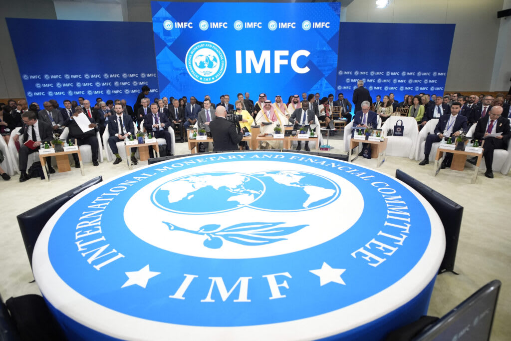 Global leaders discussing economic policies at the IMF-World Bank meetings.