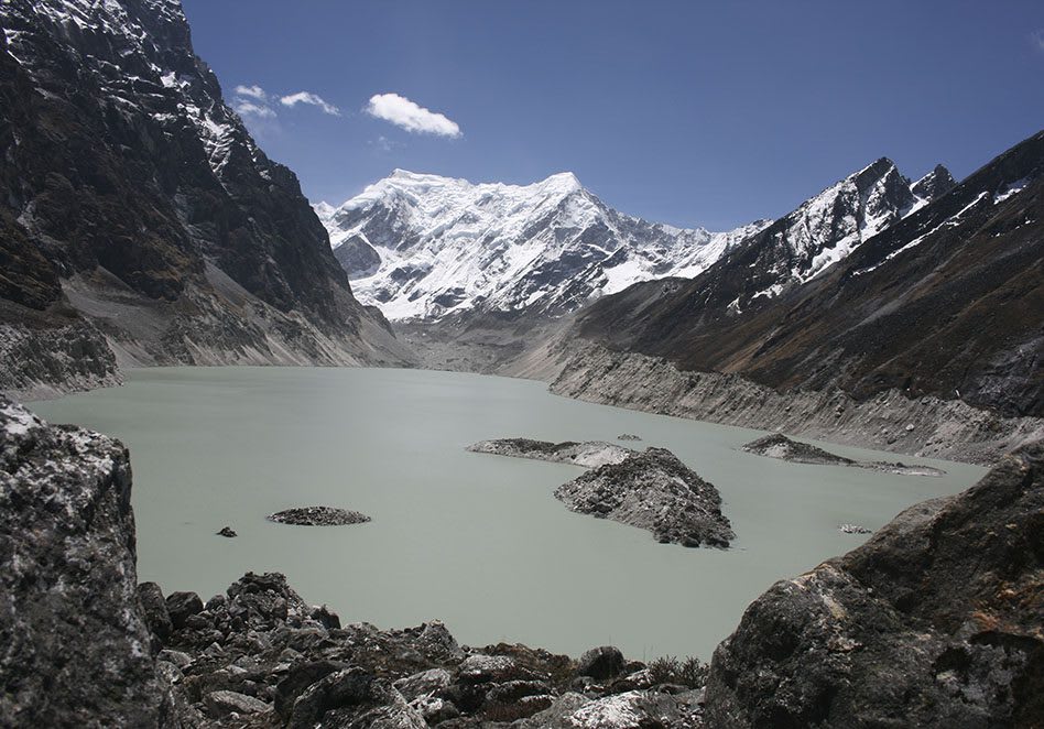 A scenic view of glaciers in Bhutan with warning signs for flood preparedness.