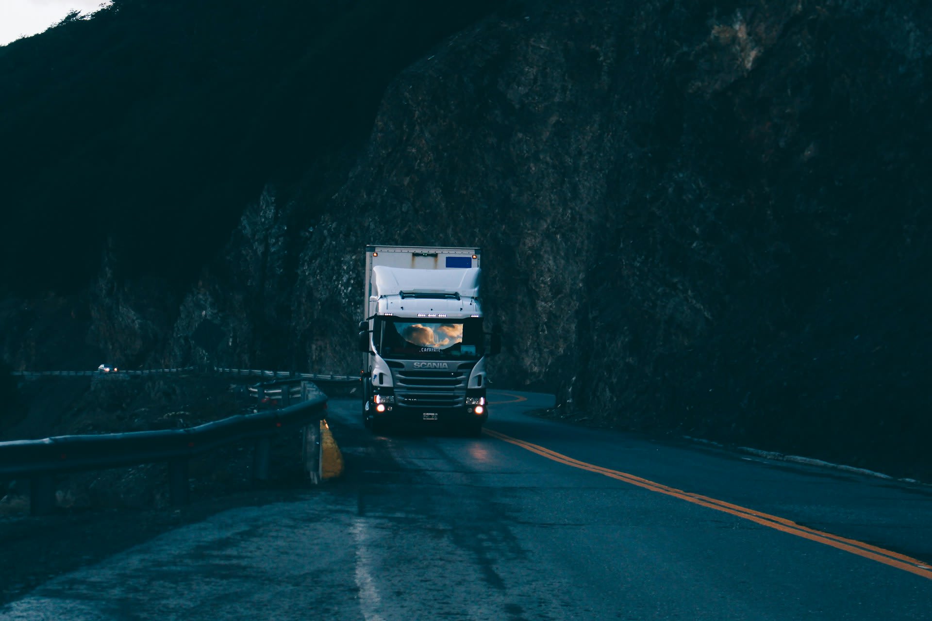 HGV on a UK motorway at dusk — inbound freight for e-commerce sellers