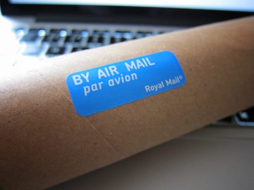 Cardboard mailing tube with air-mail shipping label — compliant packing and labelling for dispatch