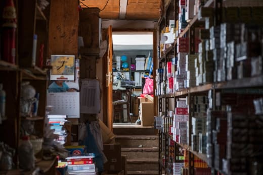 Warehouse storage aisle with shelving stacked with cartons — flexible capacity and inventory depth