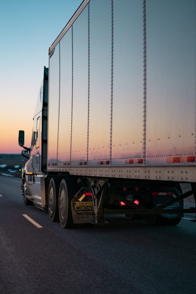 Semi-truck on a UK road at dusk — long-haul logistics and linehaul for E-Commerce