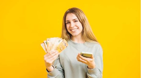 Excited woman holding money