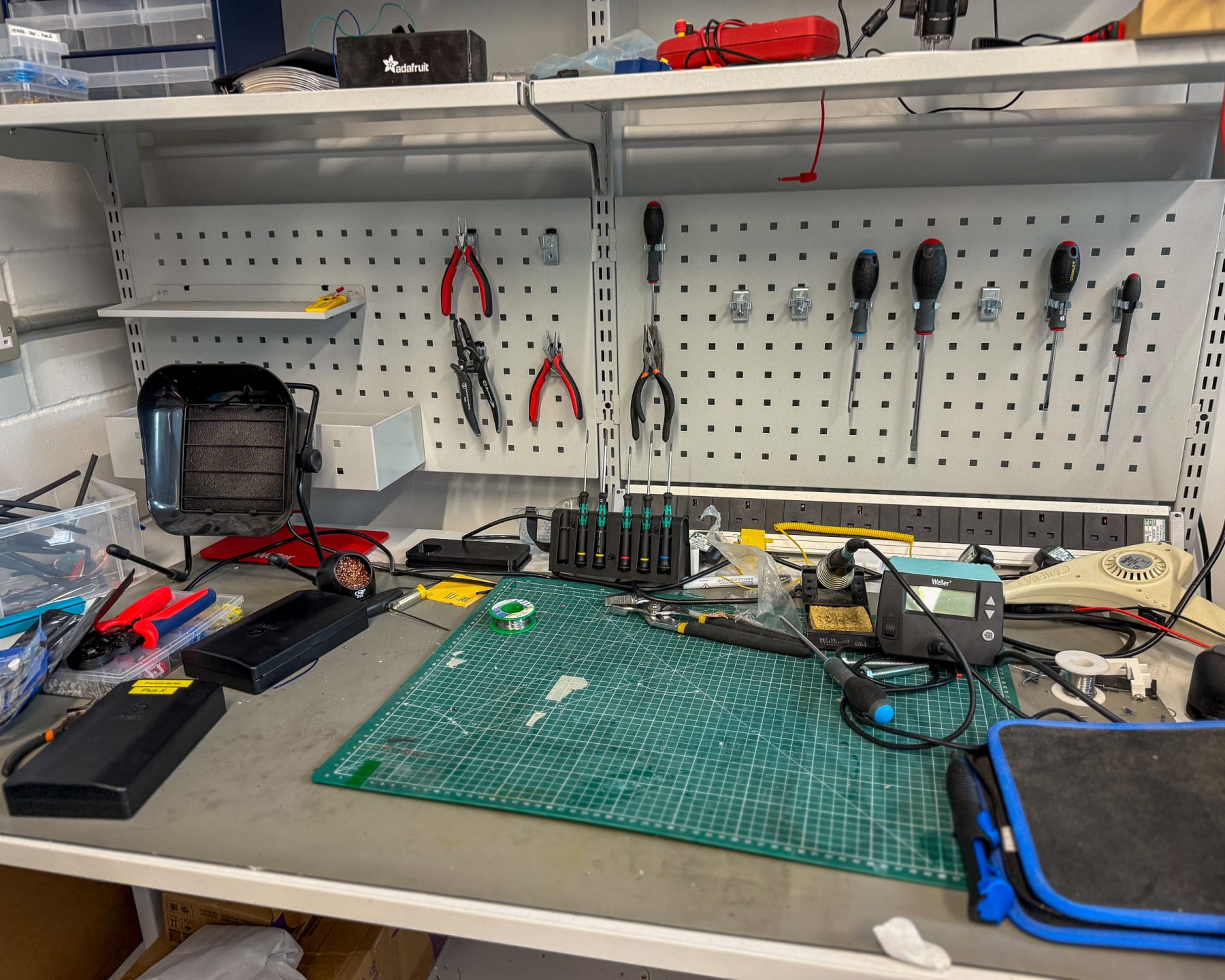 Electronics prototyping bench with benchtop power supply and soldering station