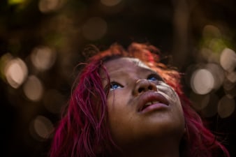 Photograph of child with red hair looking up