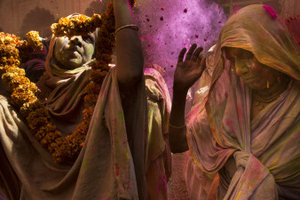 Women participate in the Holi ceremony